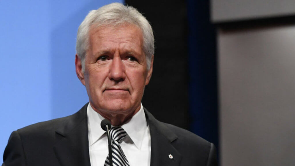 Alex Trebek in a suit with a serious face