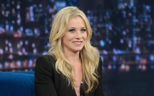 Christina Applegate smiling as she makes a guest appearance on a talk show