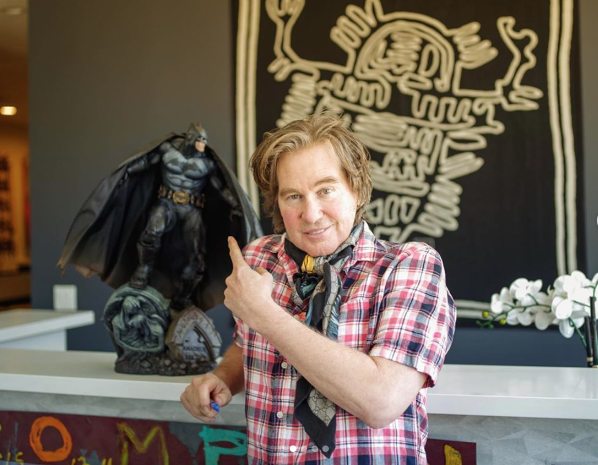 Val Kilmer posing with a bat man figurine on his instagram