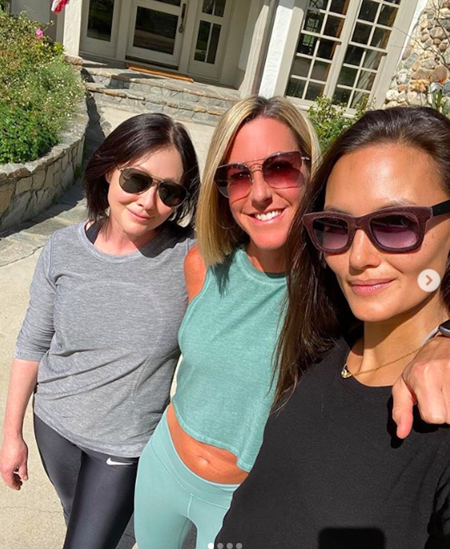 Shannen Doherty posing in a photo with two of her friends