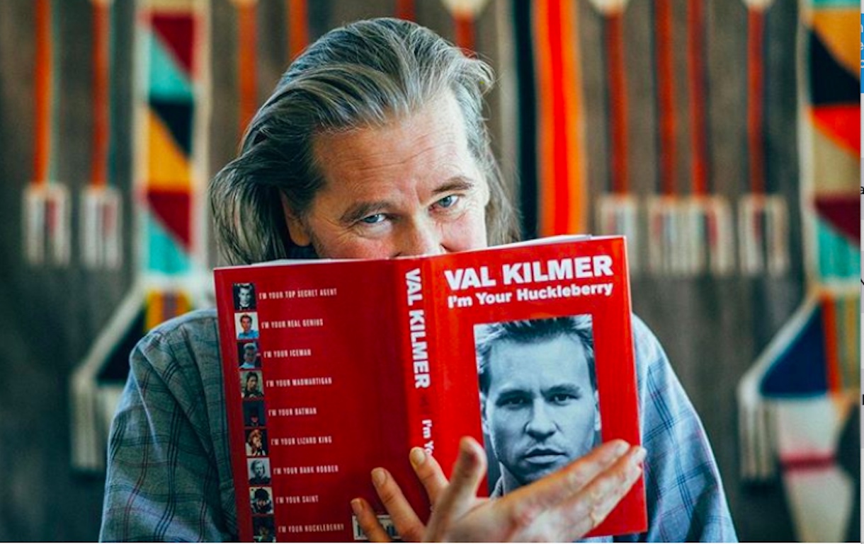 Val Kilmer posing with his bestselling book
