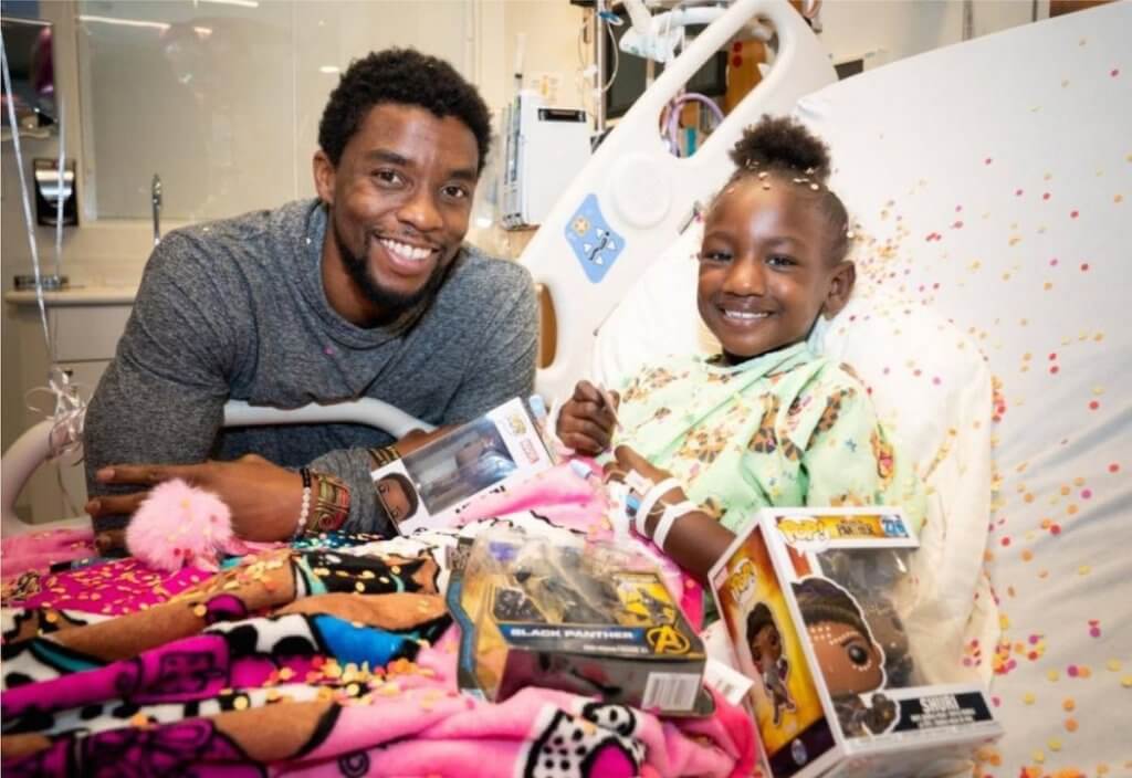 Chadwick Boseman at cancer hospital with child