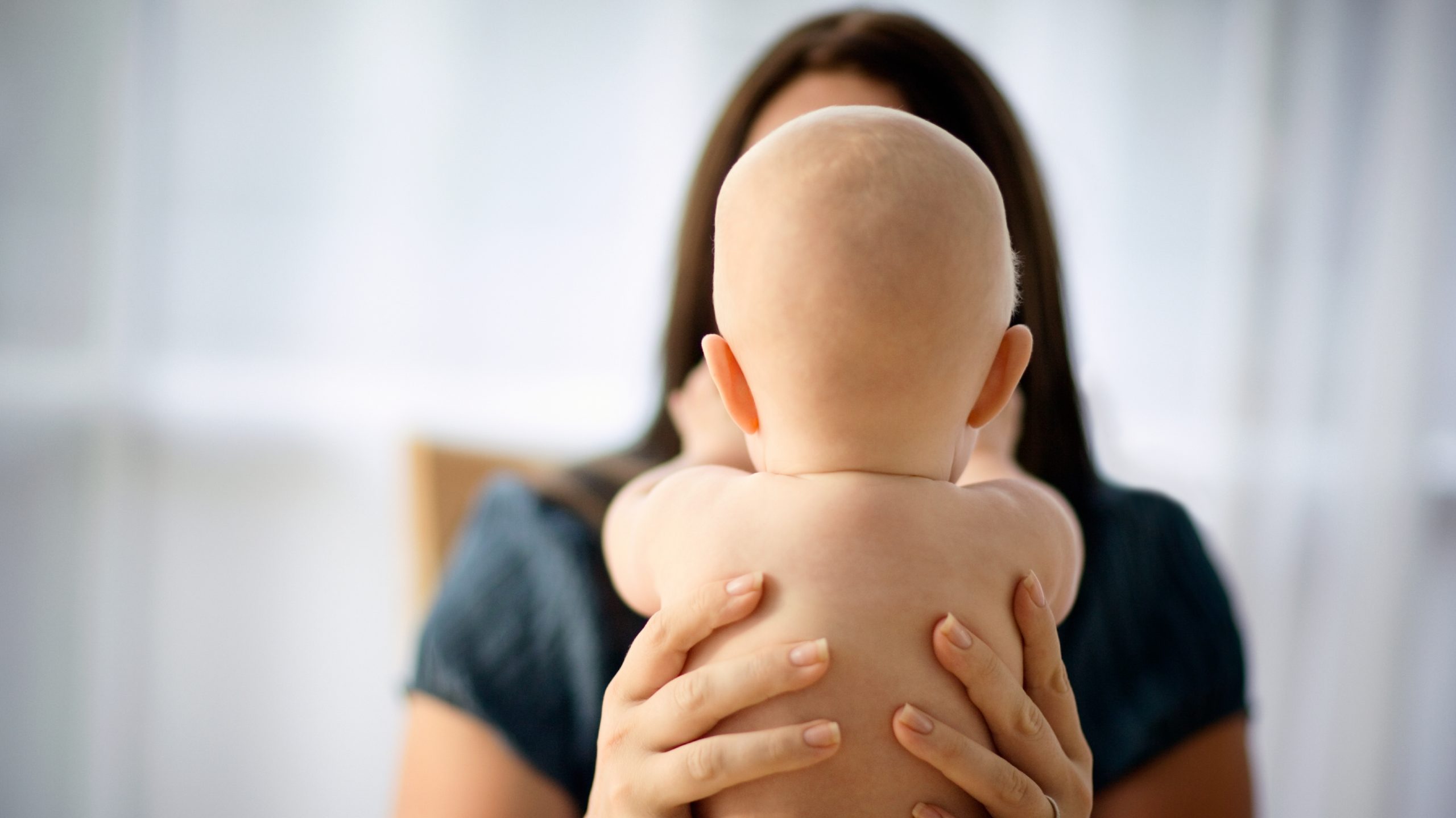 mom holding baby (Getty images)