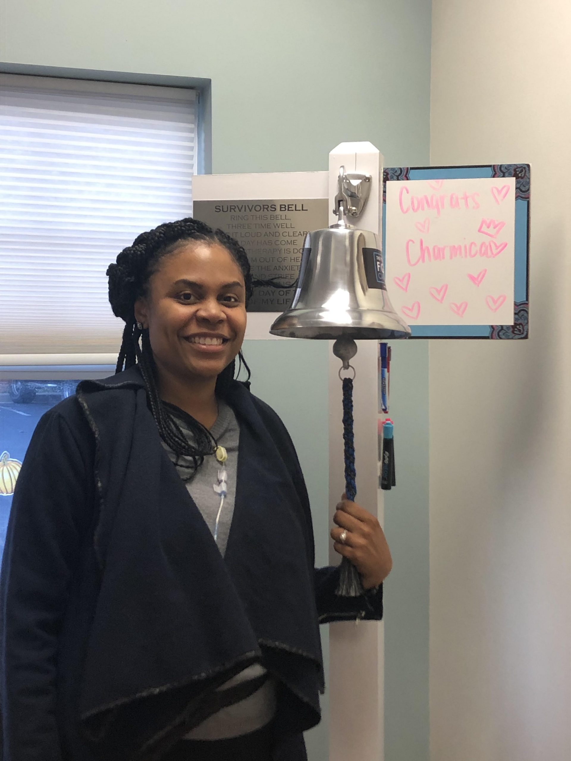 Charmica Epps ringing her bell after cancer treatment.