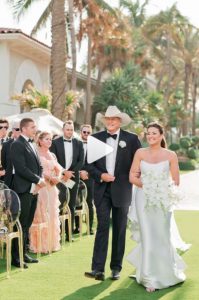 Alan Jackson walks Mattie down the aisle, in a photo as part of a video Mattie shared on Instagram (@mattiejackson).